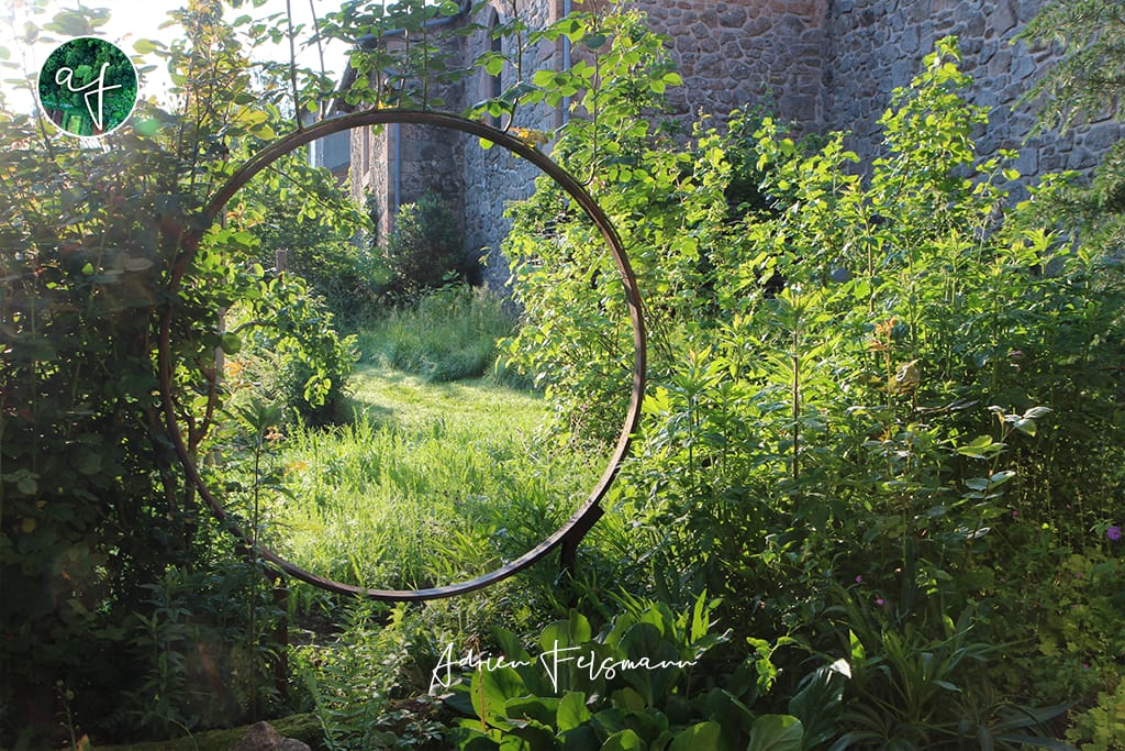 Jardin naturel vu au travers d'un cercle en métal
